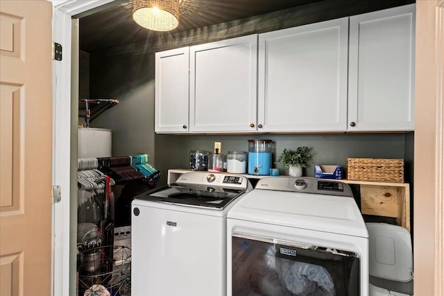 washroom with cabinet space and washer and dryer