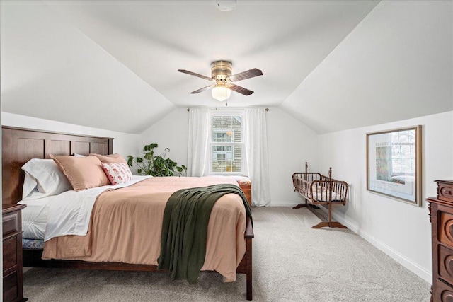 bedroom with lofted ceiling, light carpet, ceiling fan, and baseboards