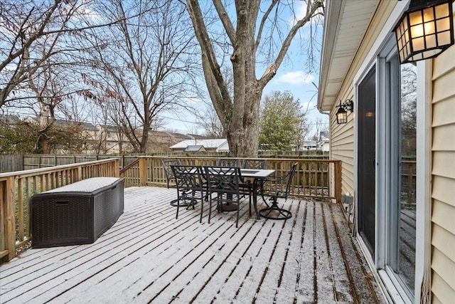 deck with outdoor dining space and fence