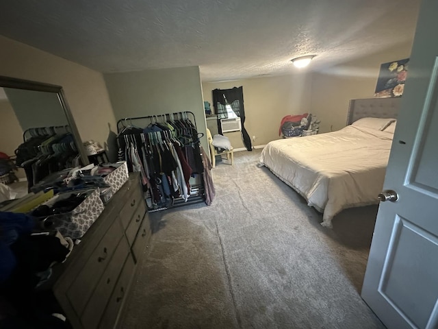 bedroom with carpet floors, a textured ceiling, and baseboards