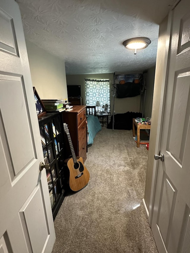 corridor featuring a textured ceiling and carpet floors