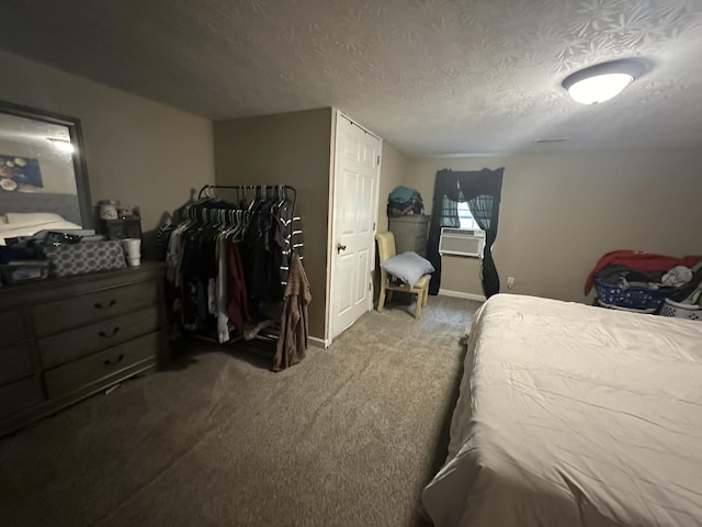 carpeted bedroom featuring a textured ceiling and baseboards