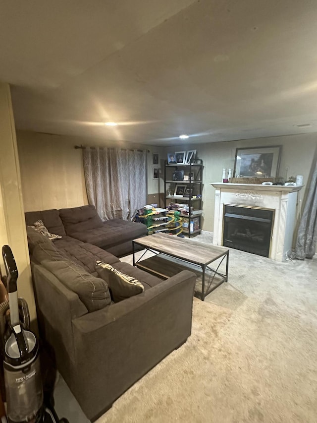 carpeted living area with a glass covered fireplace