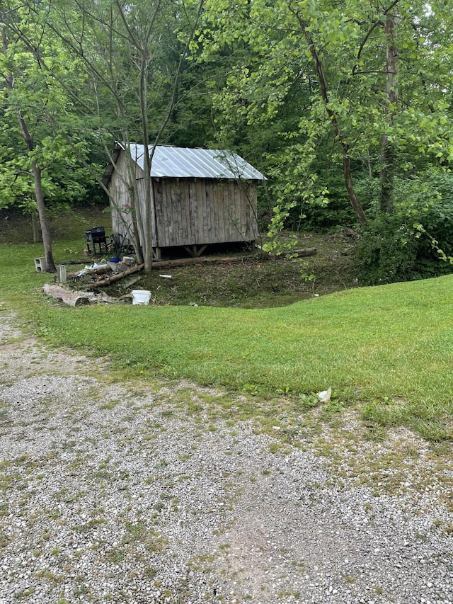 view of shed with a wooded view