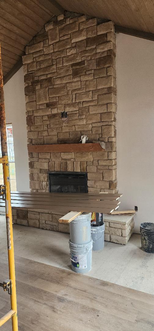 details with wood ceiling, a stone fireplace, and wood finished floors