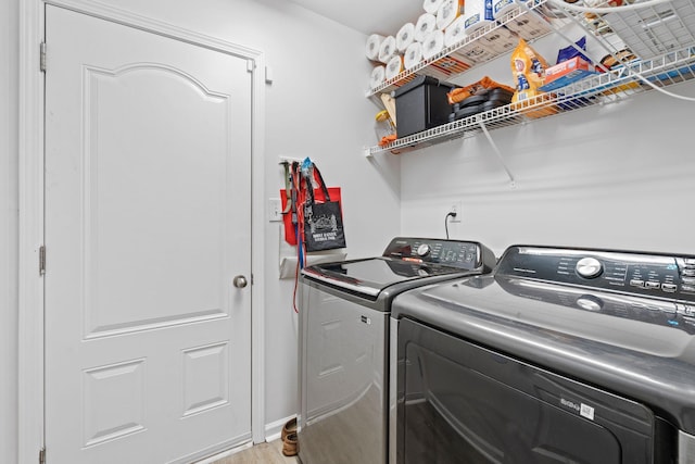 laundry room featuring laundry area, separate washer and dryer, and light wood-style floors