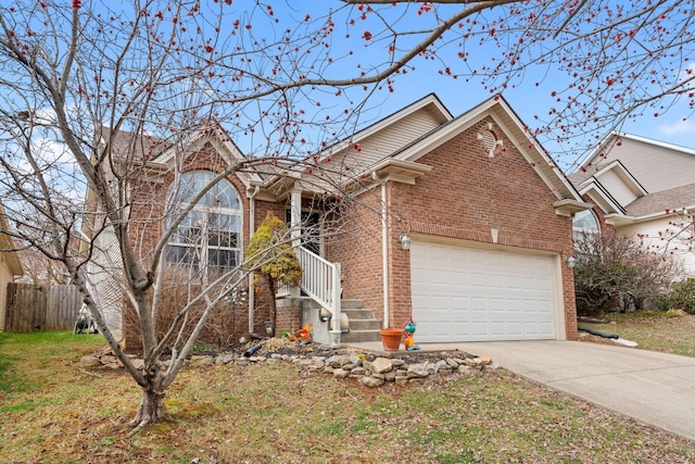 ranch-style home with a garage, driveway, brick siding, and fence