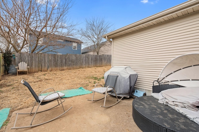 view of patio / terrace with a grill and fence