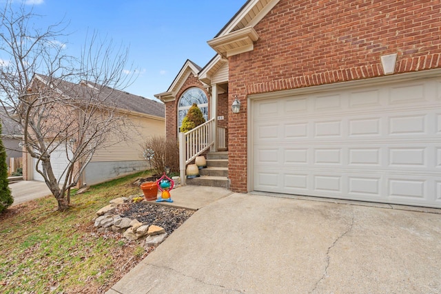 view of front of home with a garage, driveway, and brick siding