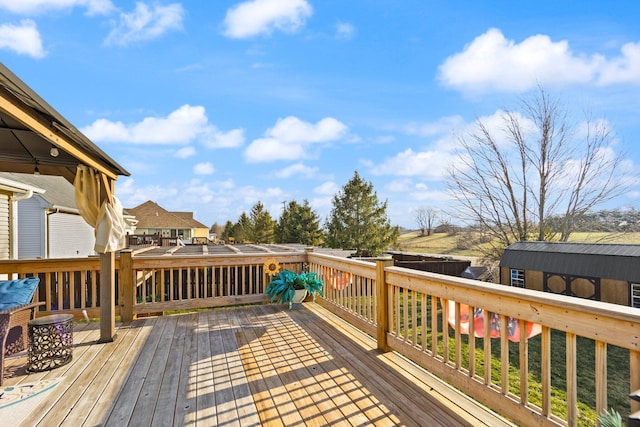 deck with an outbuilding and a storage shed