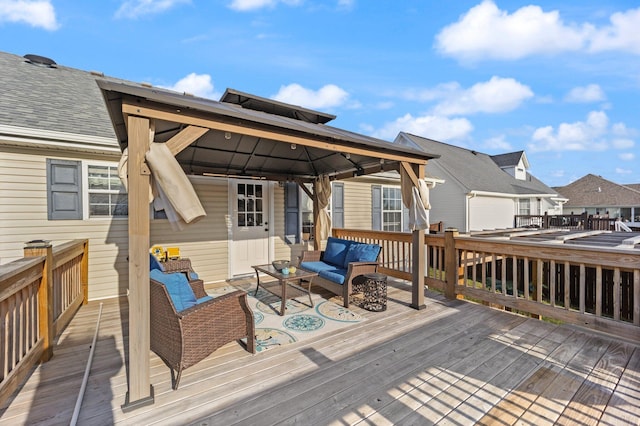 wooden terrace featuring an outdoor hangout area and a gazebo