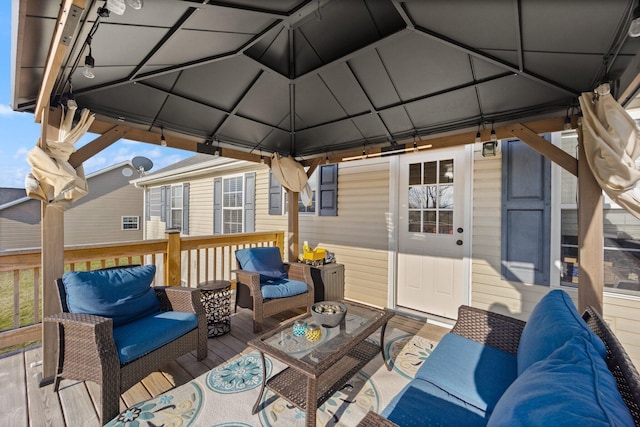 view of patio with an outdoor living space, a deck, and a gazebo