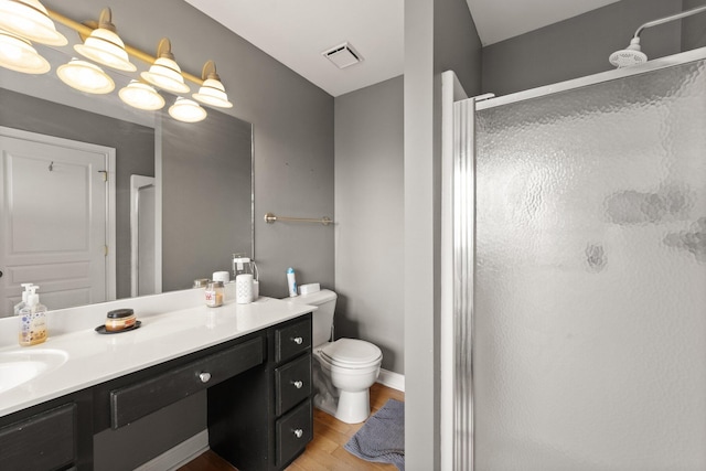 bathroom with vanity, a shower stall, and visible vents