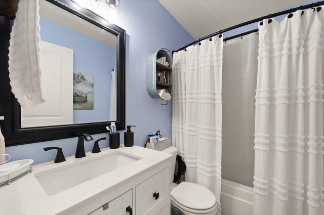 bathroom with shower / bath combo, vanity, and toilet