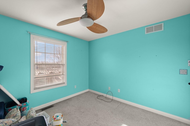 interior space with a ceiling fan, visible vents, and baseboards