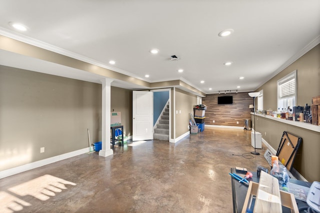 below grade area featuring baseboards, ornamental molding, stairway, and recessed lighting