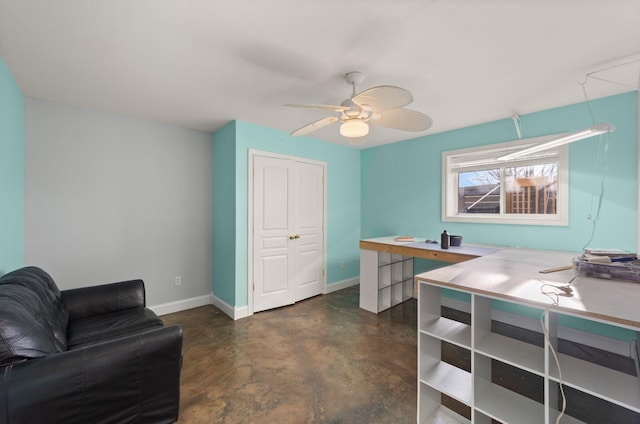 office with ceiling fan, concrete floors, and baseboards