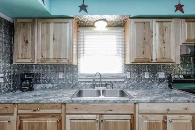 kitchen featuring electric range, a sink, wall chimney exhaust hood, light brown cabinetry, and tasteful backsplash