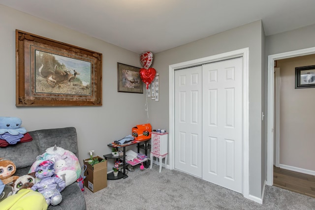 rec room featuring carpet and baseboards