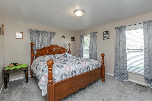 bedroom featuring carpet floors, visible vents, and baseboards