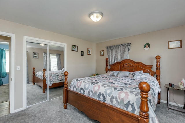 carpeted bedroom featuring baseboards