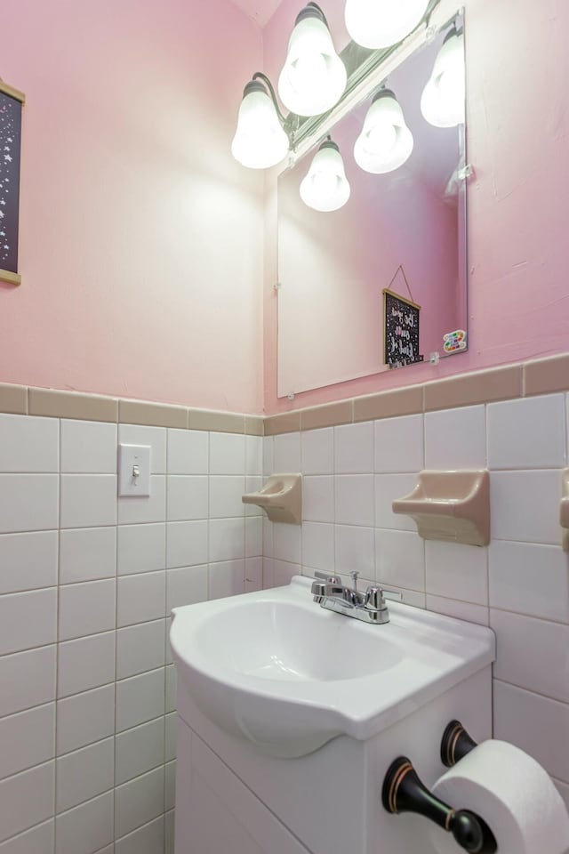 bathroom featuring wainscoting, vanity, and tile walls