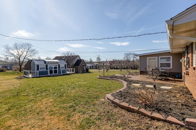 view of yard featuring a patio area and an outdoor structure