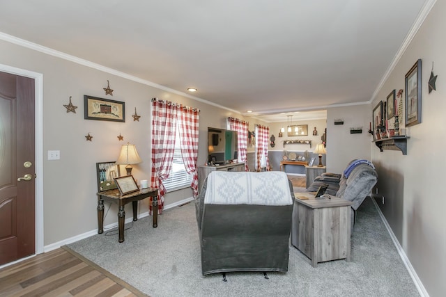 living room with ornamental molding, wood finished floors, and baseboards