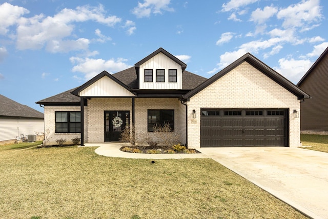 modern farmhouse style home featuring an attached garage, central air condition unit, brick siding, driveway, and a front yard