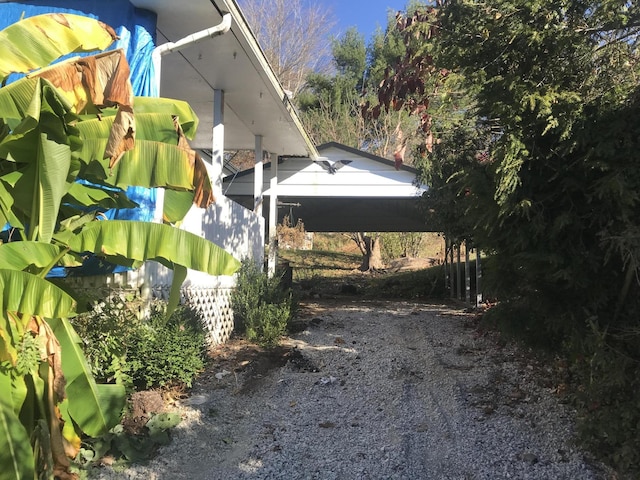 view of side of property with a carport and fence