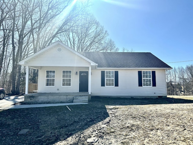 view of front of property with a porch and roof with shingles