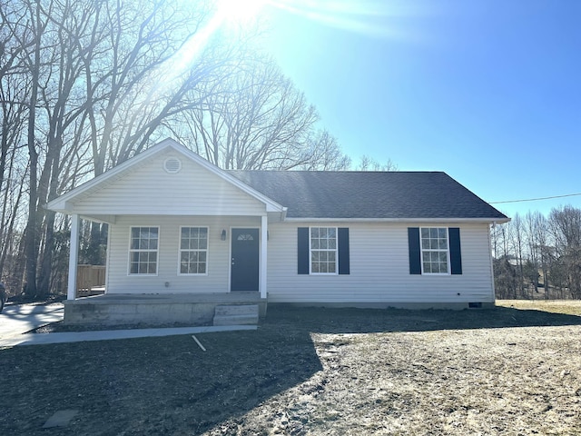 view of front of house featuring covered porch and roof with shingles