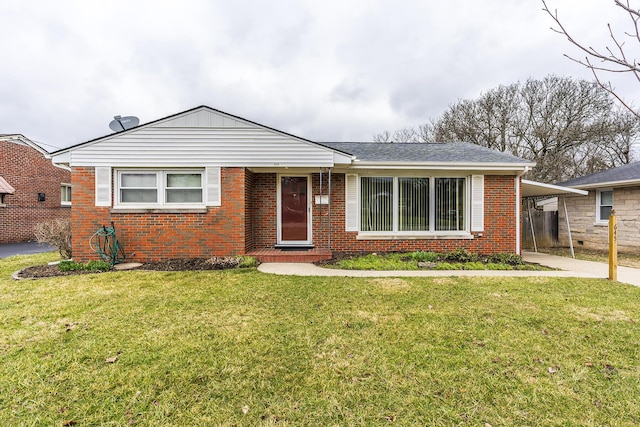 view of front of home with driveway, roof with shingles, a front lawn, and brick siding