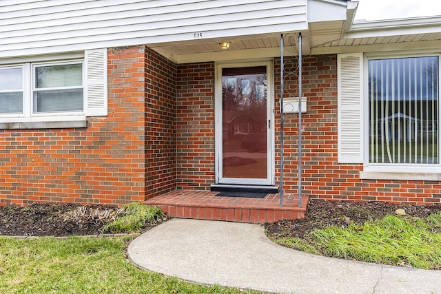 property entrance featuring brick siding