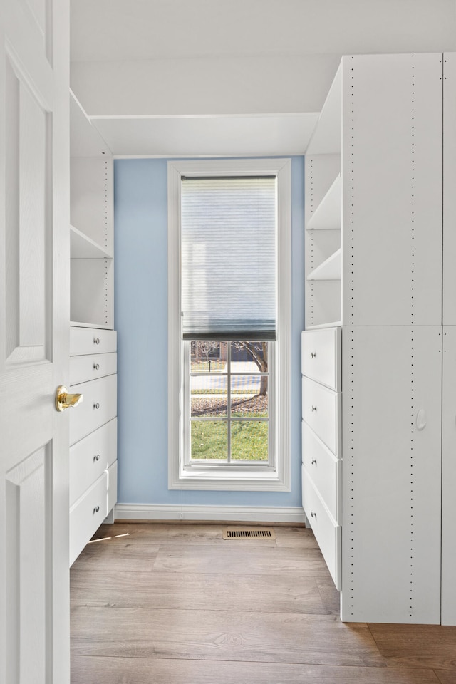 spacious closet featuring visible vents and wood finished floors