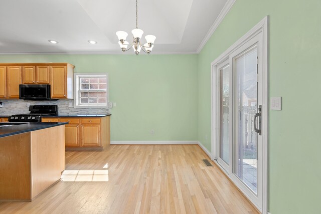 kitchen featuring dark countertops, visible vents, decorative backsplash, gas stove, and black microwave