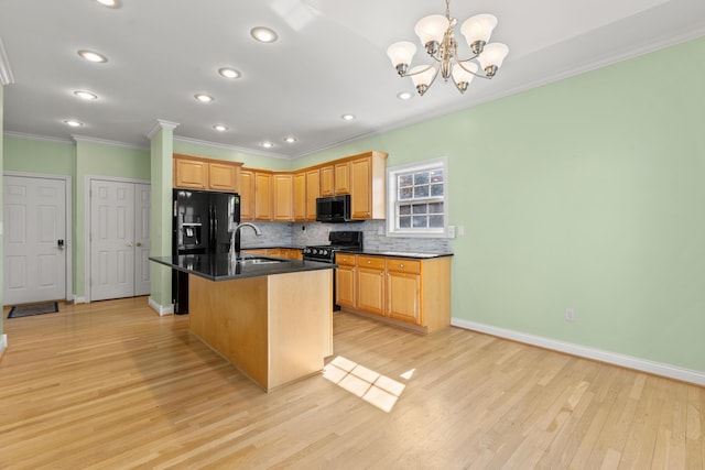 kitchen featuring a sink, light wood-type flooring, black appliances, tasteful backsplash, and dark countertops