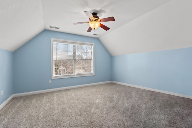 bonus room featuring lofted ceiling, carpet, visible vents, and baseboards