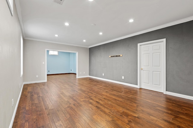 unfurnished room with hardwood / wood-style flooring, baseboards, and crown molding