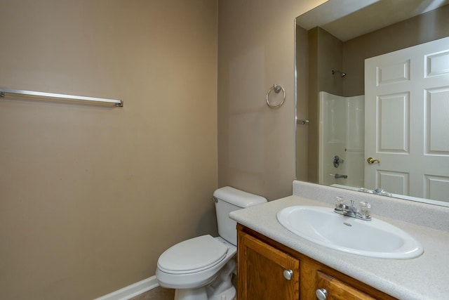 bathroom featuring vanity, walk in shower, toilet, and baseboards