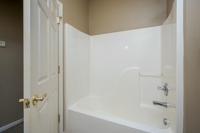 full bath featuring baseboards and shower / washtub combination