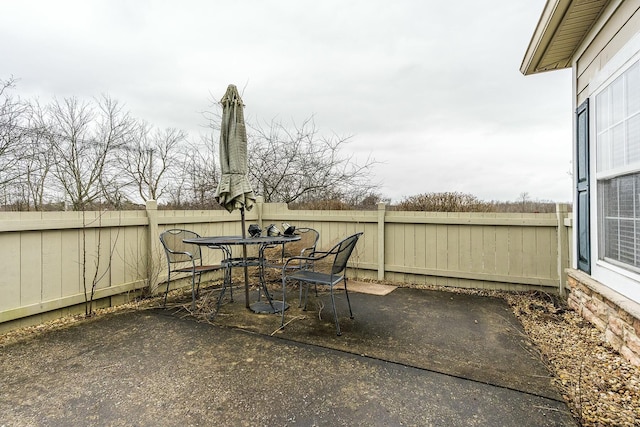 view of patio with outdoor dining area and a fenced backyard