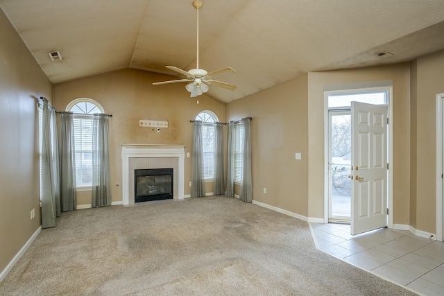 unfurnished living room featuring carpet floors, tile patterned floors, visible vents, and a tile fireplace