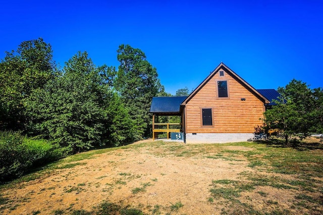 view of property exterior with metal roof and crawl space