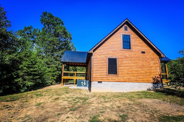 view of side of property featuring crawl space, metal roof, and cooling unit