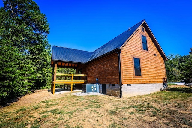 view of side of home featuring a deck, metal roof, crawl space, and central air condition unit