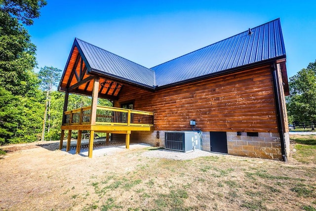 back of property featuring metal roof and central AC unit