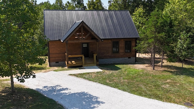 view of front of house featuring metal roof, a porch, crawl space, and a front lawn