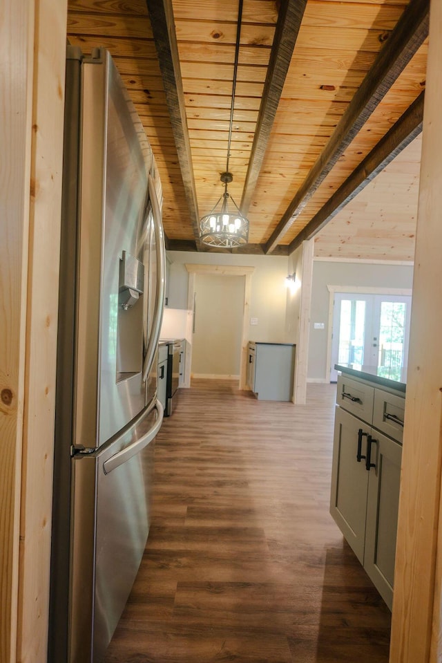 kitchen with dark wood-style flooring, wood ceiling, open floor plan, stainless steel fridge, and an inviting chandelier