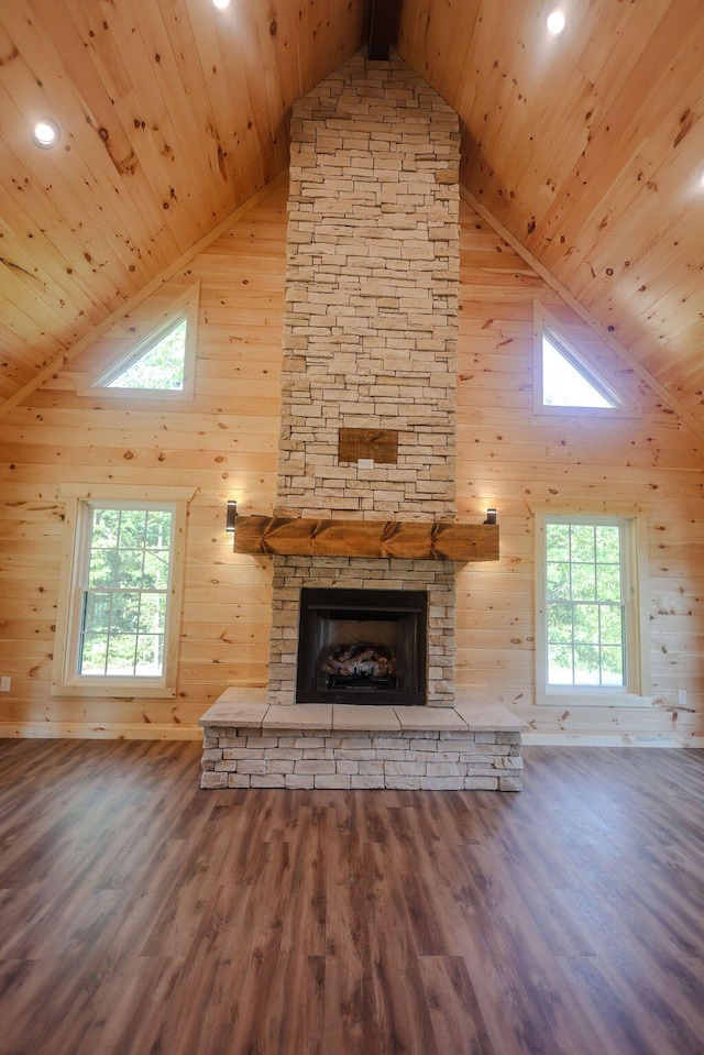 unfurnished living room featuring a fireplace, wood finished floors, and wooden ceiling